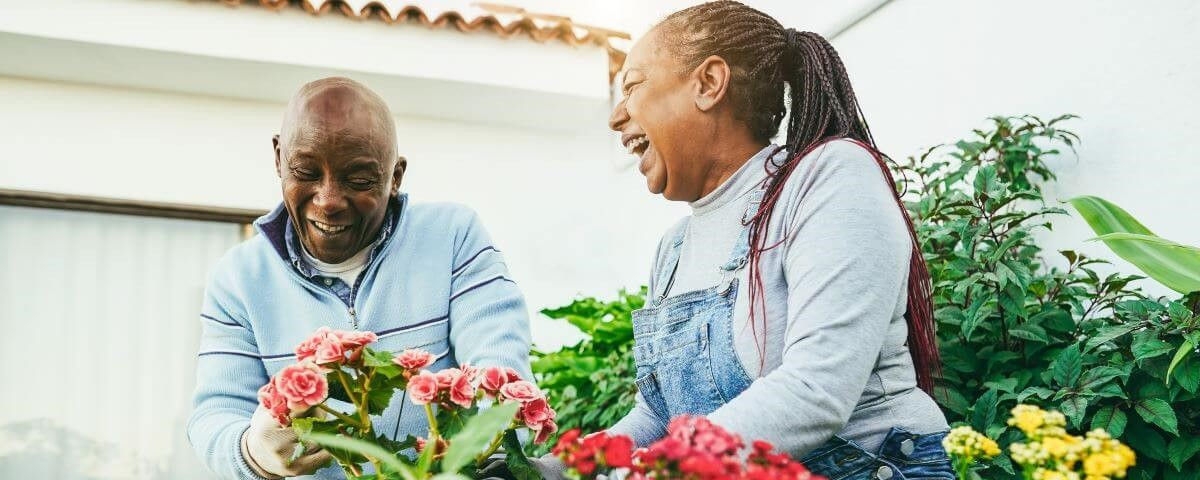 Multiracial women preparing flowers plants at home patio garden