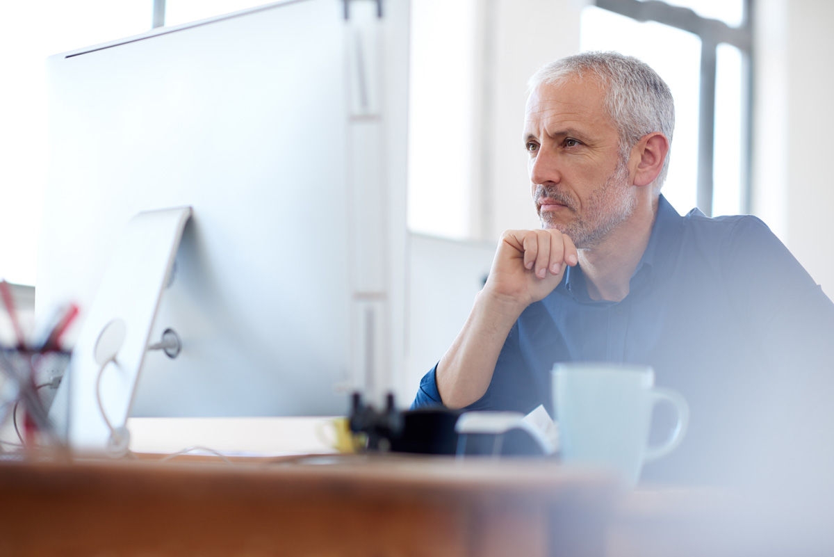 Low angle view of a mature professional man looking intently at his pchttp://195.154.178.81/DATA/shoots/ic_784739.jpg