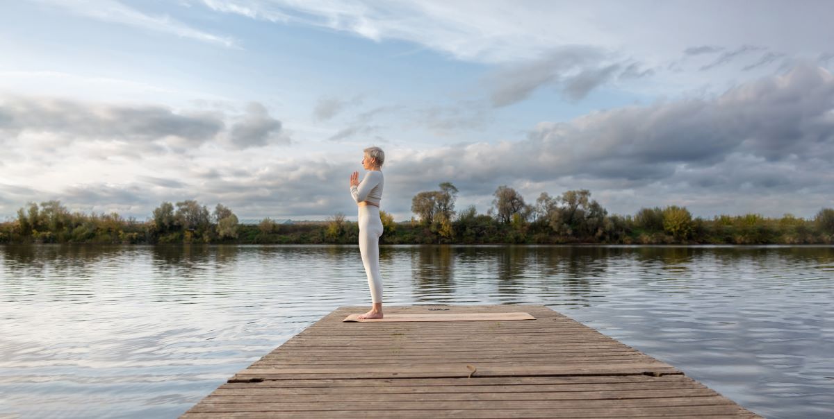 woman doing yoga on dock