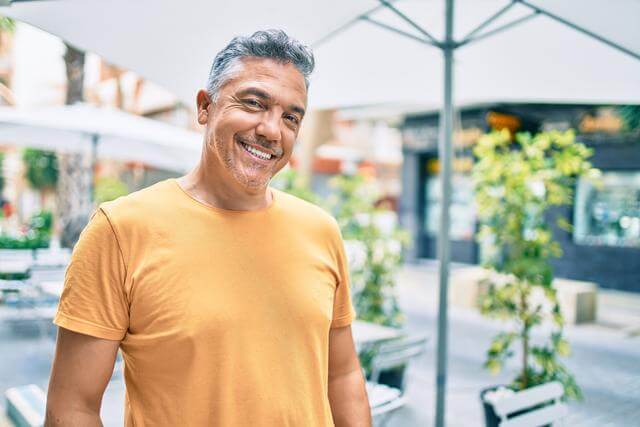 Man smiling in a restaurant setting